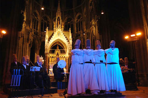 Whirling dervishes beginning to dance in a Catholic Cathedral